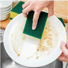 Load image into Gallery viewer, Person cleaning a plate with a green sponge in a kitchen setting
