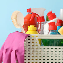 Load image into Gallery viewer, Basket filled with cleaning supplies including bottles, a sponge, and a scrub brush on a light blue background.
