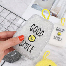 Load image into Gallery viewer, Person holding a glittery pouch with &#39;Good Smile&#39; text and smiley face.
