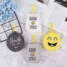 Load image into Gallery viewer, Four smiling emoji keychains on a marble surface with a book and blue flowers in the background.
