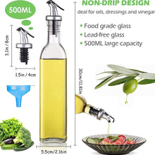 Load image into Gallery viewer, A 500ml clear glass oil bottle with a silver and black pour spout, shown on a white background with text highlighting non-drip design, food grade glass, and large capacity. The image includes dimension labels, a blue funnel, vegetables, and a salad with oil being poured from the bottle.
