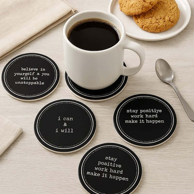 Set of motivational coasters with a cup of coffee and cookies on a table.