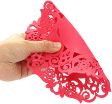 Load image into Gallery viewer, Hand holding a red laser-cut decorative paper with intricate patterns on a white background

