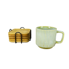 تحميل الصورة في عارض المعرض، Green mug with gold stripes on a wooden coaster, surrounded by plants and coasters, with &#39;El Ameed&#39; branding.
