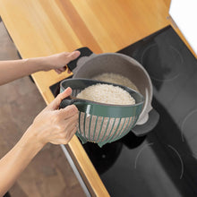 Load image into Gallery viewer, Hands rinsing ingredients in a handled bowl over a kitchen sink
