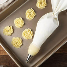 Load image into Gallery viewer, Cream pastry bag with buttercream roses on a baking tray, ideal for cupcake decoration and professional baking.
