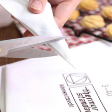 Load image into Gallery viewer, Cutting the tip of a cream pastry bag for cake decoration, showcasing a professional reusable cotton piping bag.
