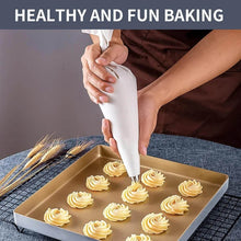 Load image into Gallery viewer, Professional cream pastry bag decorating cupcakes with buttercream swirls on a baking tray.
