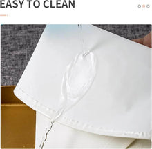Load image into Gallery viewer, Close-up of a cream pastry bag showing its easy-to-clean feature with liquid flowing on the surface.
