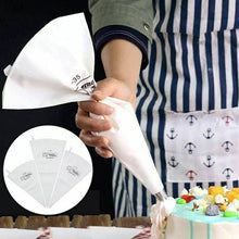 Load image into Gallery viewer, Professional cream pastry bag in use for decorating cupcake cake with detailed designs.
