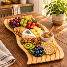 تحميل الصورة في عارض المعرض، A set of wavy, light-colored wooden food trays stacked on top of a dark wood table, with a paper label attached to the center tray.
