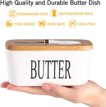 Load image into Gallery viewer, White butter dish with wooden lid held in a hand, featuring safety icons.
