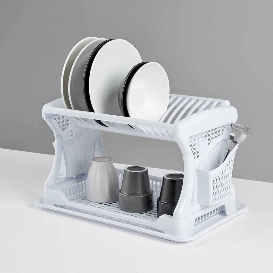 White dish rack with plates and cups on a gray background