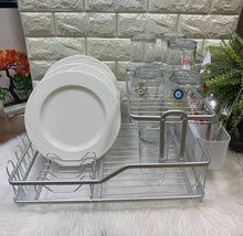 تحميل الصورة في عارض المعرض، Dish rack with plates and glasses on a stone wall background
