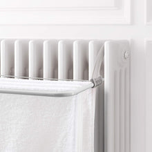 Load image into Gallery viewer, White radiator with a towel hanging on it against a white wall

