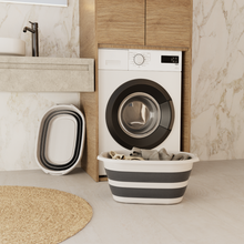 تحميل الصورة في عارض المعرض، Washing machine in a modern laundry room with a striped laundry basket and buckets.
