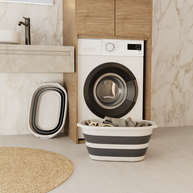 Washing machine in a modern laundry room with a striped laundry basket and buckets.