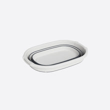 تحميل الصورة في عارض المعرض، Set of two white ceramic dishes with black interior on a light gray background
