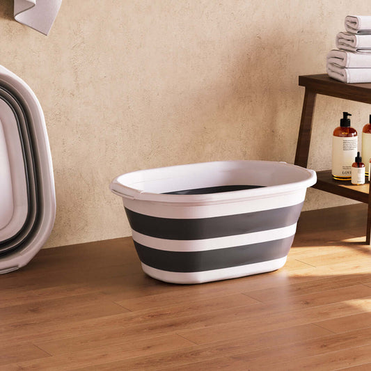 Open white and grey collapsible laundry basket in a bathroom