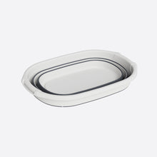 تحميل الصورة في عارض المعرض، Set of two white ceramic trays with black interior on a light gray background
