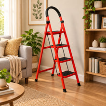 Load image into Gallery viewer, A red three-step folding step ladder with black non-slip rubberized steps and a black curved handguard, shown in a room setting with a white wall and floor, alongside paint cans and a brush.

