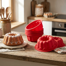 Load image into Gallery viewer, Red silicone bundt cake mold on a white background
