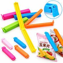 تحميل الصورة في عارض المعرض، A variety of colorful food lock clips in different sizes, displayed alongside a bag of chips to showcase their use.
