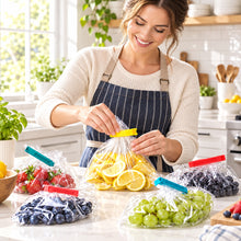تحميل الصورة في عارض المعرض، Person packaging fruits into clear bags with colorful clips on a white surface.
