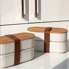 Load image into Gallery viewer, Set of three kitchen containers with wooden lids on a light-colored surface.
