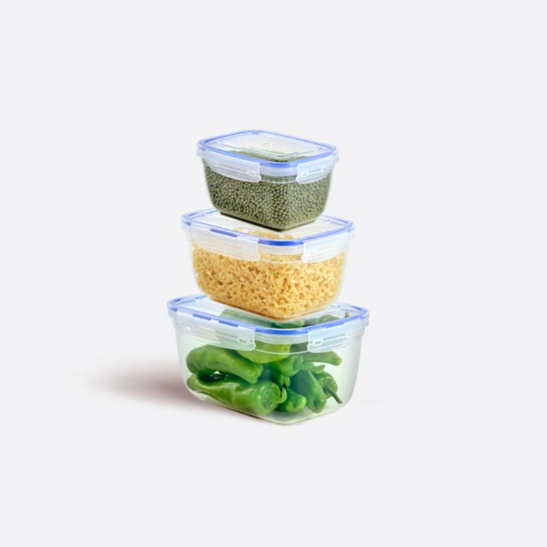 Stack of four clear food storage containers with different contents on a white background