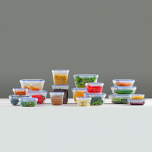 Load image into Gallery viewer, Set of food containers with various food items on a gray background

