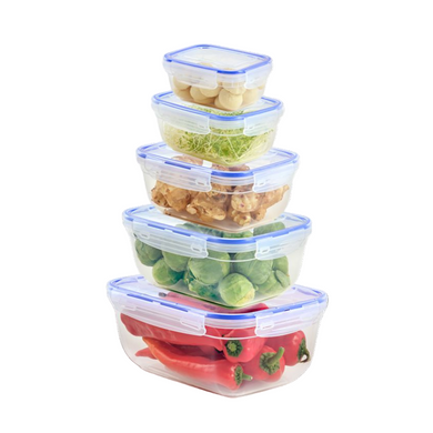A set of five sealed rectangular food storage containers in various sizes, stacked together, with the contents visible through the transparent containers. The contents include what appears to be nuts, leafy vegetables, and bell peppers.
