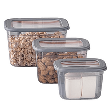 Load image into Gallery viewer, A set of three clear food storage containers with corresponding gray silicone lids, filled with different types of dry food items like nuts and grains.
