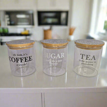 Load image into Gallery viewer, Three glass jars with wooden lids labeled &#39;Coffee&#39;, &#39;Sugar&#39;, and &#39;Tea&#39; on a kitchen counter.
