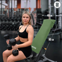 Load image into Gallery viewer, Woman holding dumbbells in a gym setting with a green weight bench labeled &#39;Gym Stitch&#39;.
