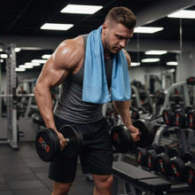 تحميل الصورة في عارض المعرض، Muscular man exercising with dumbbells in a gym setting
