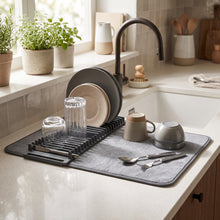 Load image into Gallery viewer, Grey drying mat with a black dish rack beside a kitchen sink
