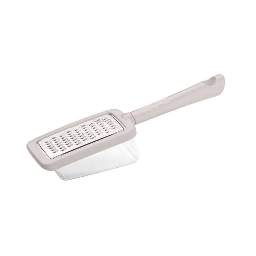 Stainless steel cheese grater with a container and ergonomic handle, featuring a flat surface with grating lines.
