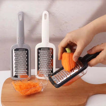تحميل الصورة في عارض المعرض، Three cheese graters with different sizes on a wooden board, with one being used to grate a small pumpkin.
