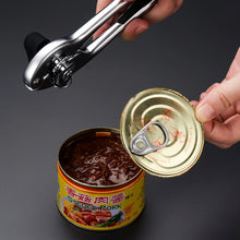 Load image into Gallery viewer, Person using a heavy-duty stainless steel can opener on a canned food container, showcasing ease of use.
