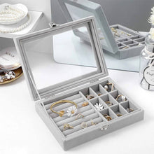 Load image into Gallery viewer, Gray jewelry box with mirror lid containing various jewelry items on a white surface.
