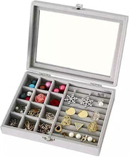 Load image into Gallery viewer, Jewelry box with compartments filled with various earrings on a white background
