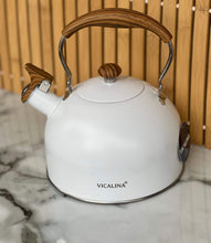 Load image into Gallery viewer, White kettle with wooden handles on a marble surface
