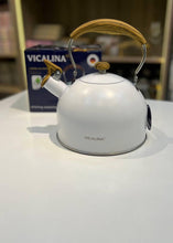 Load image into Gallery viewer, White kettle with wooden handle on a white surface, Vicalina brand visible
