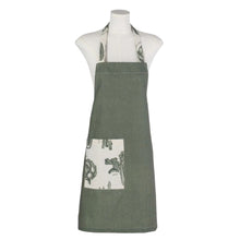 تحميل الصورة في عارض المعرض، Green apron with a white pocket featuring black leaf pattern on a mannequin against a white background
