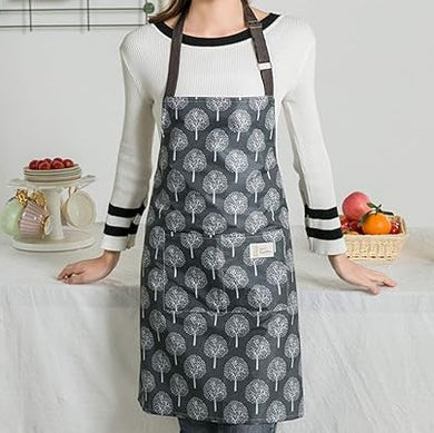 Person wearing a gray apron with tree pattern in a kitchen setting