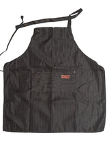 Load image into Gallery viewer, Black apron with a brand logo on a white blanket
