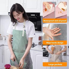 Load image into Gallery viewer, Woman in kitchen wearing a green apron with apron features highlighted.
