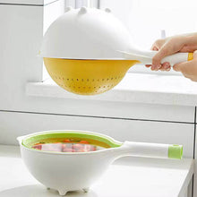تحميل الصورة في عارض المعرض، Person using a white and yellow colander with a green base on a kitchen counter.
