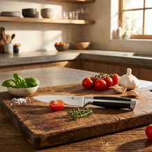 Load image into Gallery viewer, Knife with black handle and silver blade on a clear background
